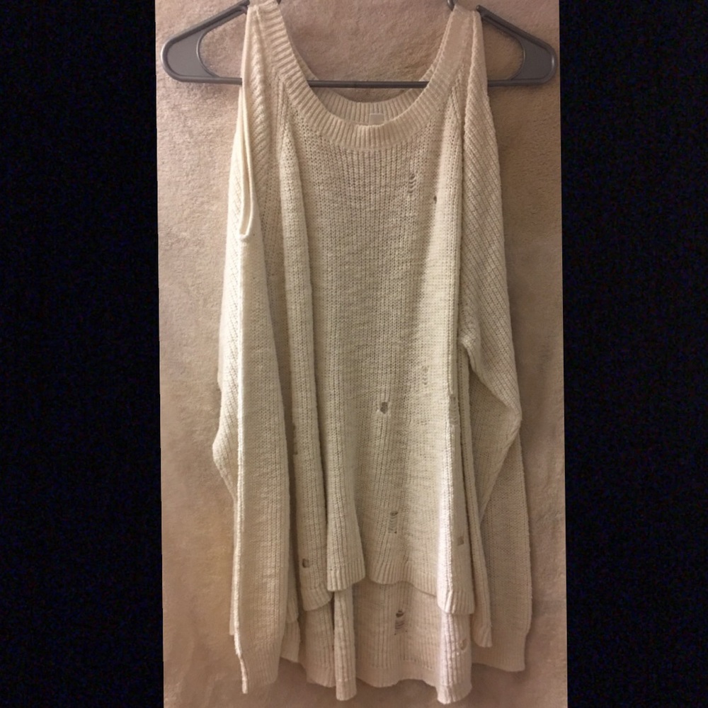 Cold shoulder distressed sweater blouse.